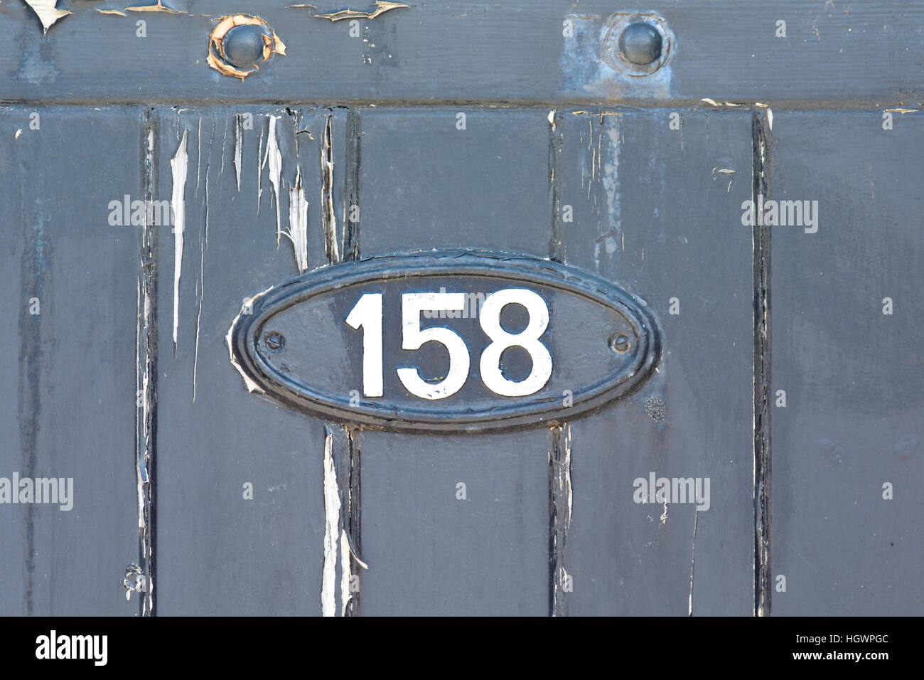 House Number 158 sign on wooden gate Stock Photo