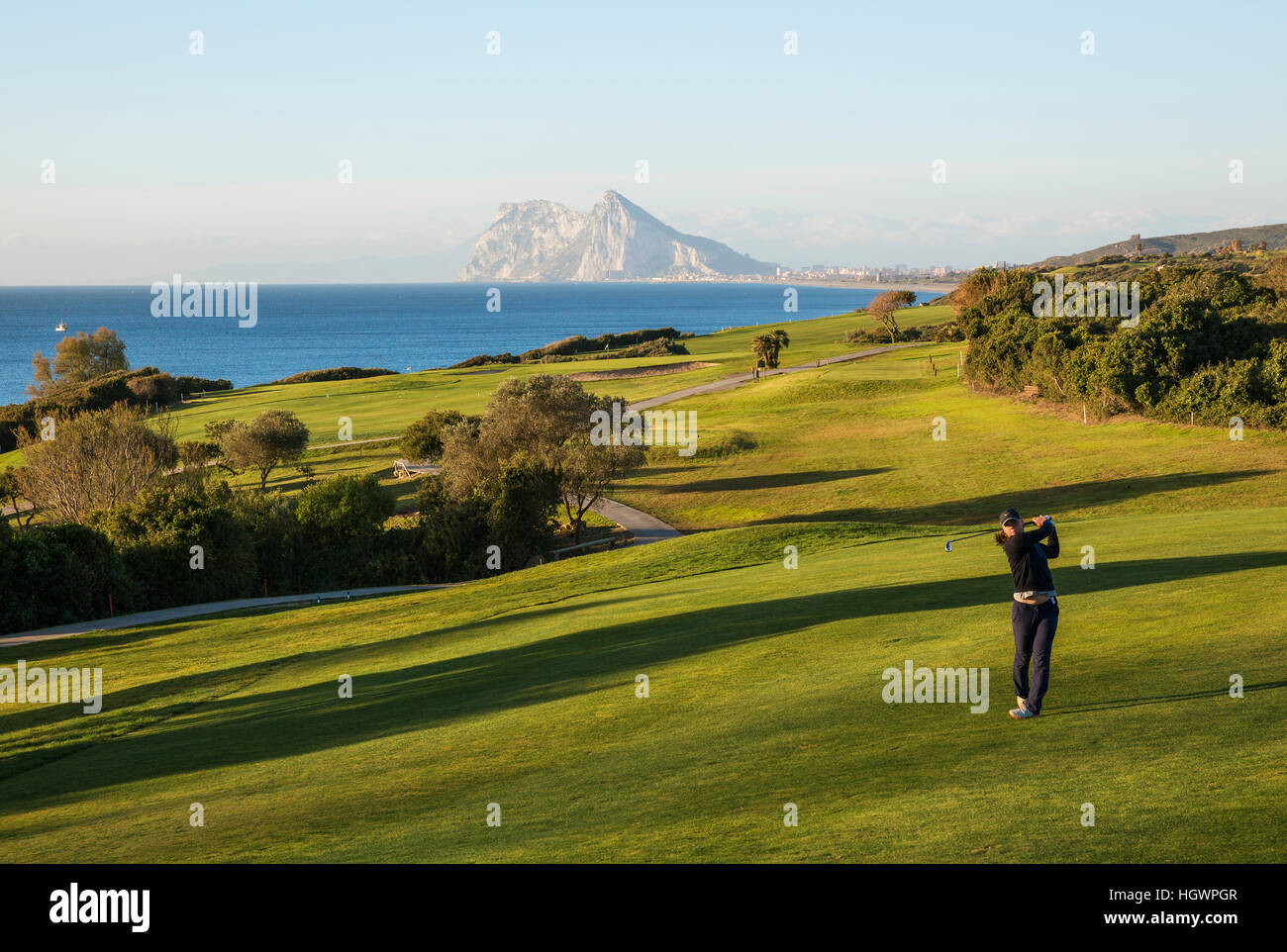Golfer at La Alcaidesa Golf Resort with Mediterranean Sea and Rock of Gibraltar, Cádiz, Andalusia, Spain Stock Photo