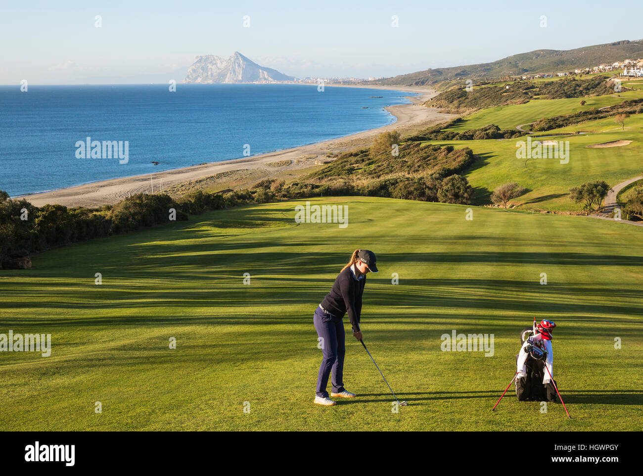 Golfer at La Alcaidesa Golf Resort with Mediterranean Sea and Rock of Gibraltar, Cádiz, Andalusia, Spain Stock Photo