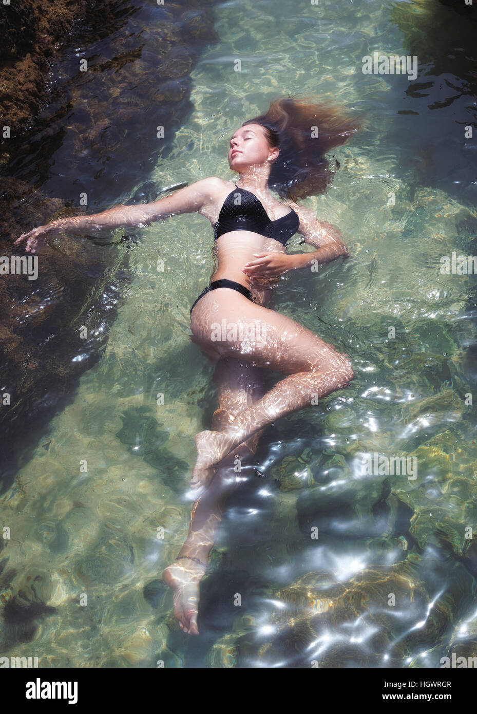 Young woman relaxing in water. Stock Photo