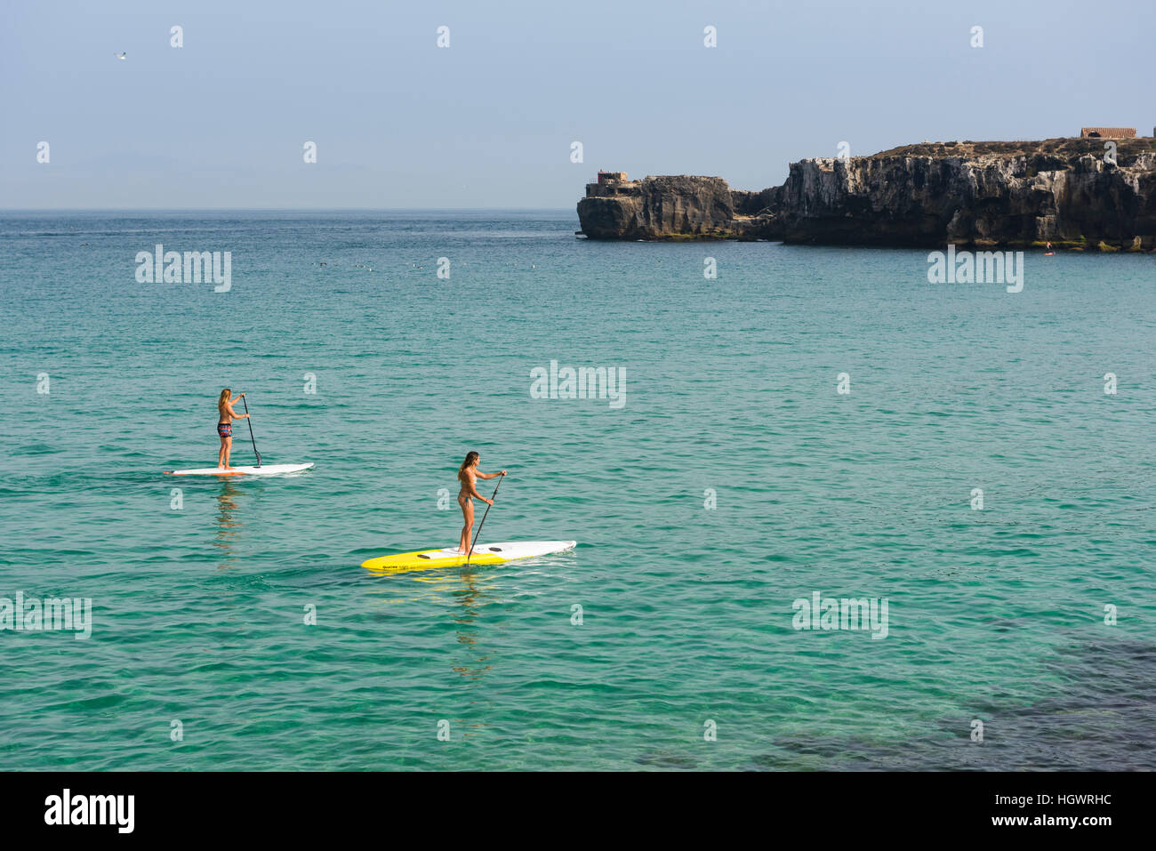 Women enjoying stand up paddle surf. Tarifa, Costa de la Luz, Cadiz, Andalusia, Spain. Stock Photo