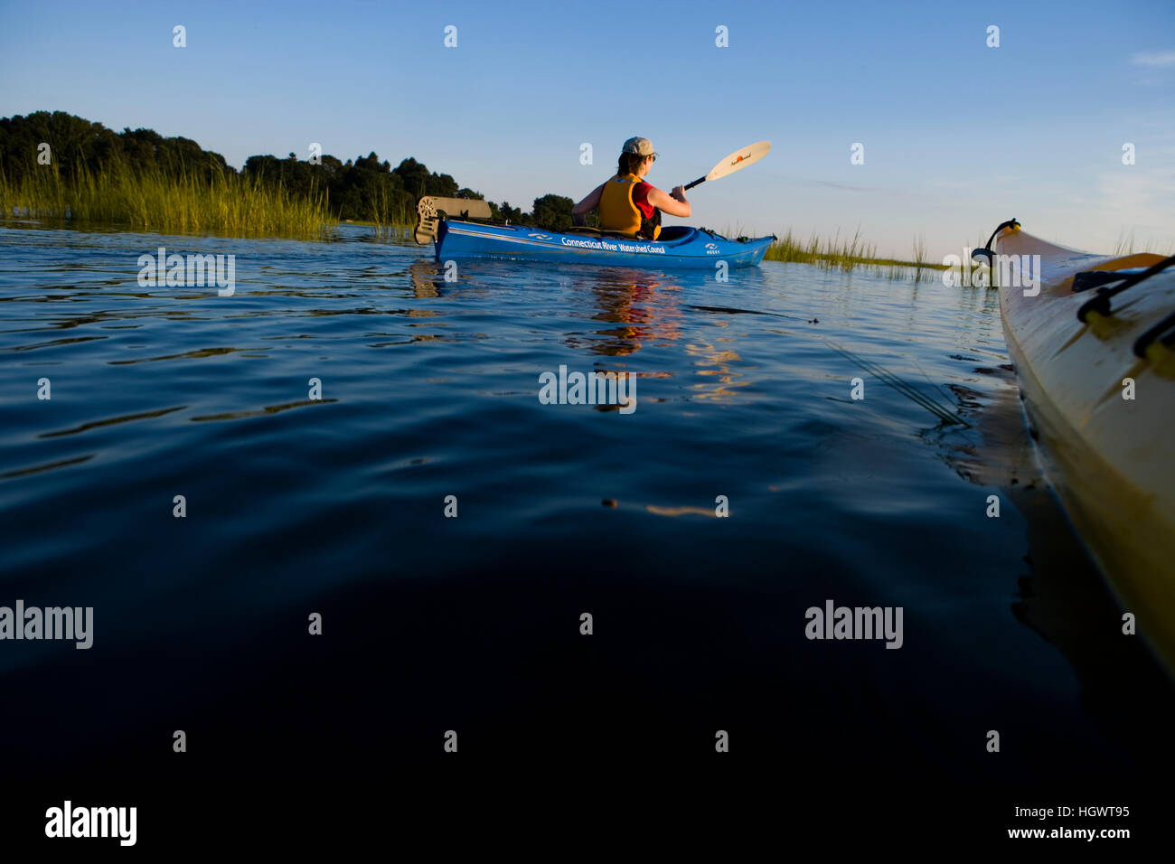 A woman kayaks in the Black Hall River near the mouth of the ...