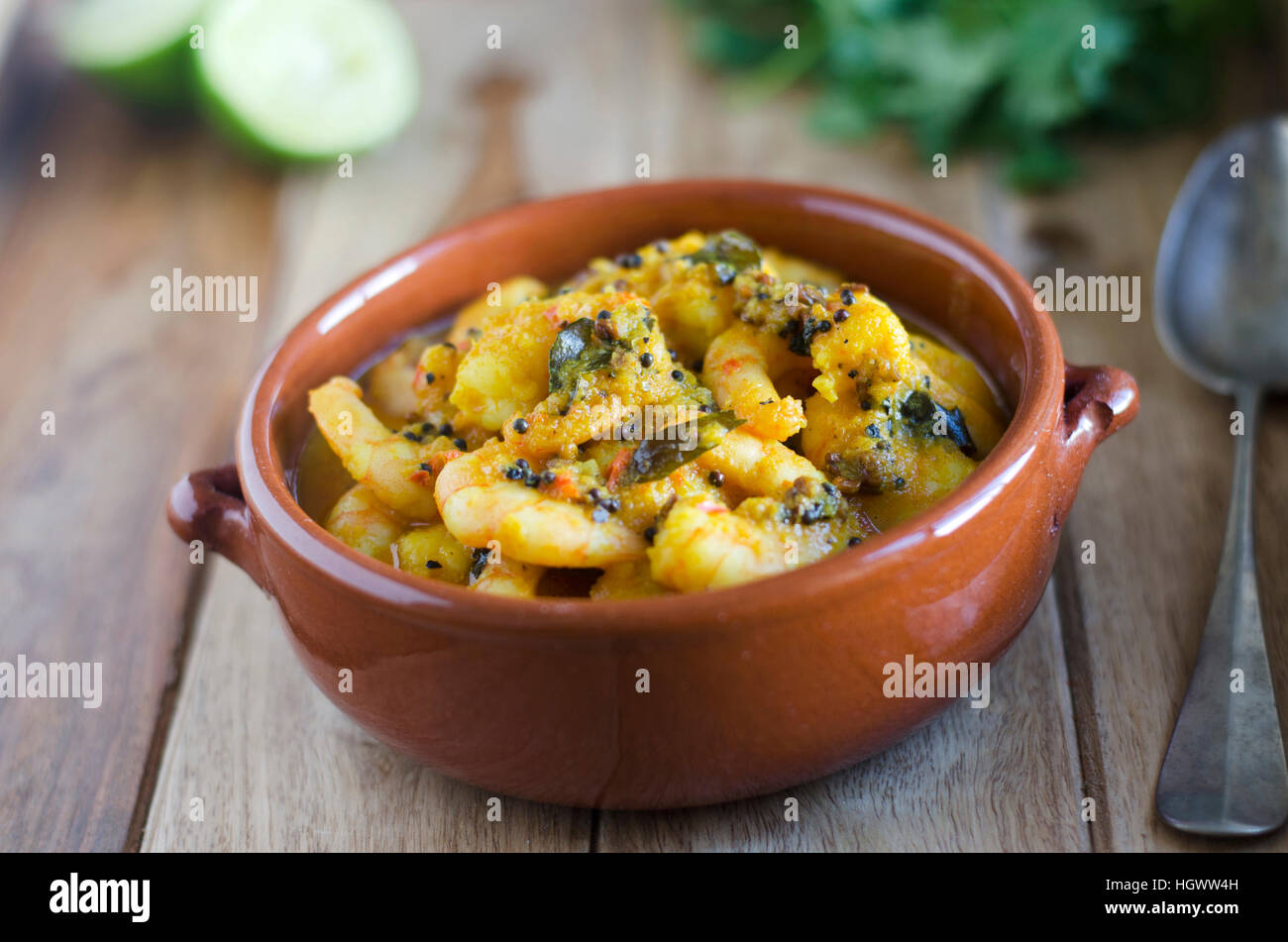 Traditional Keralan prawn curry topped with coriander leaves Stock