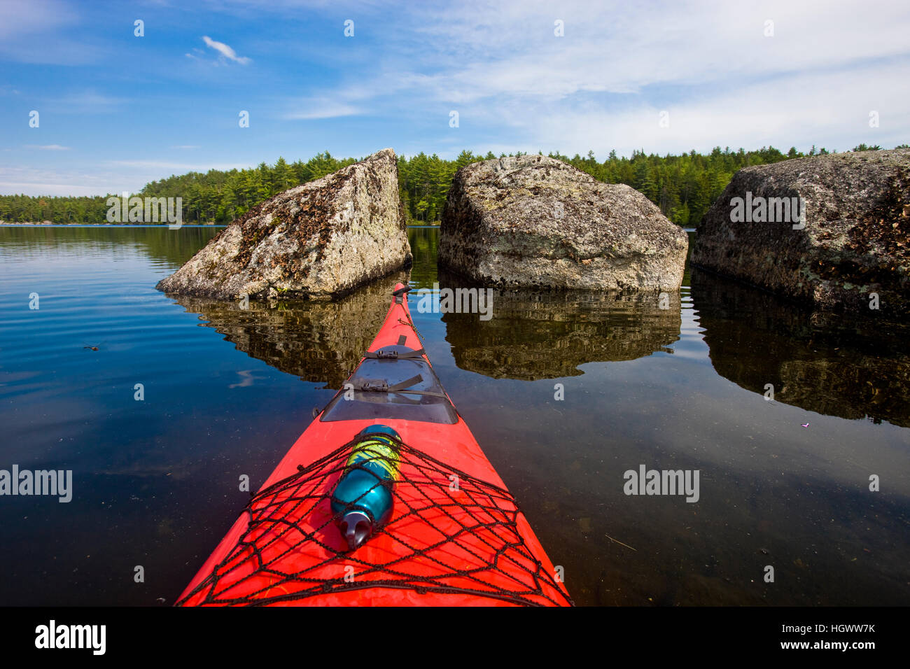 The bow of a kayak points at two large boulders in Branch Lake in