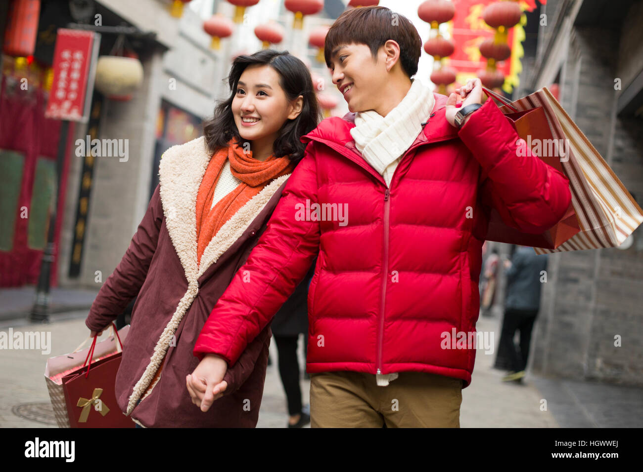 Happy young couple shopping for Chinese New Year Stock Photo - Alamy