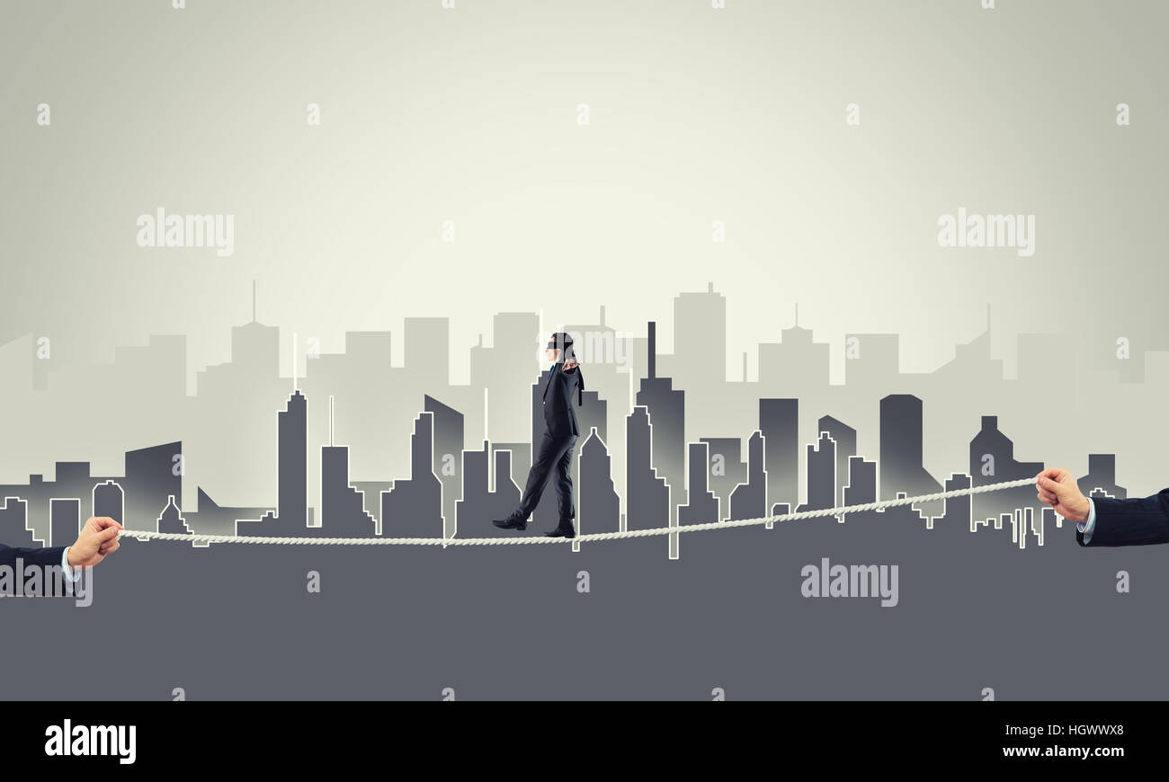 Business concept of risk support and assistance with man balancing on ...