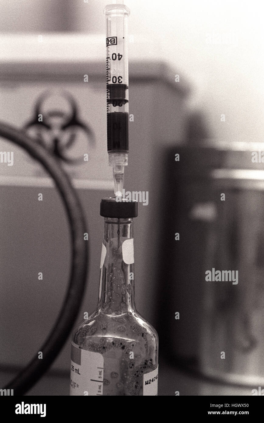 Bottle in hospital pathology department with syringe Stock Photo