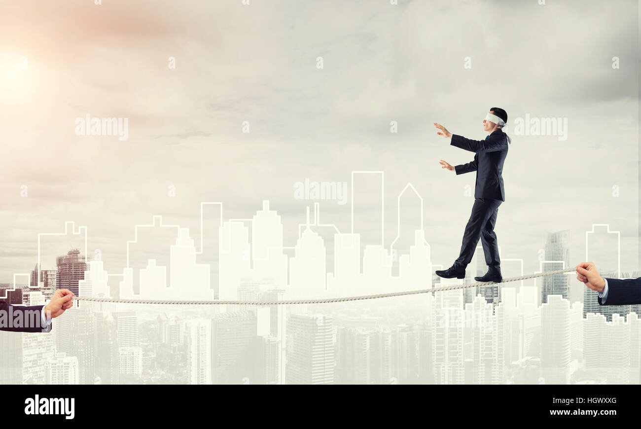 Business concept of risk support and assistance with man balancing on ...