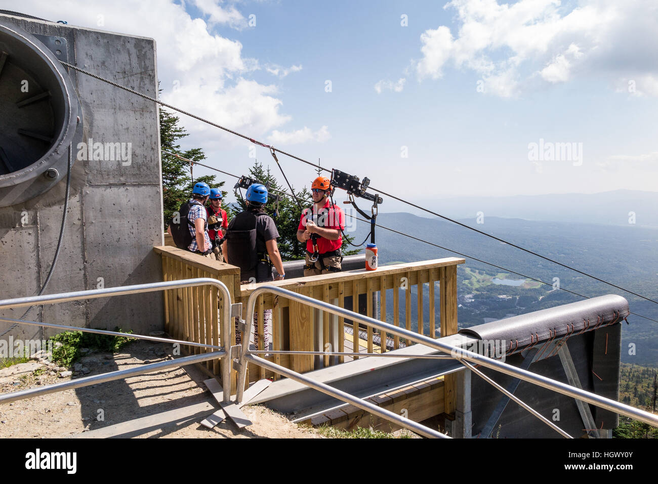 Thrill seekers getting ready to go down the zip line from the top of the Mt. Mansfield at the Stowe Ski Resort Stock Photo