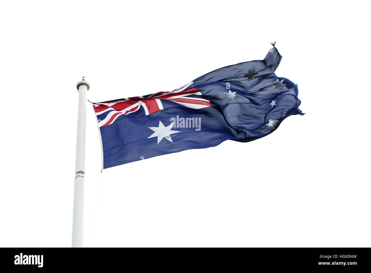 The Australian Flag. Hoist on a large flag pole in a reserve, a large Australian flag is blown