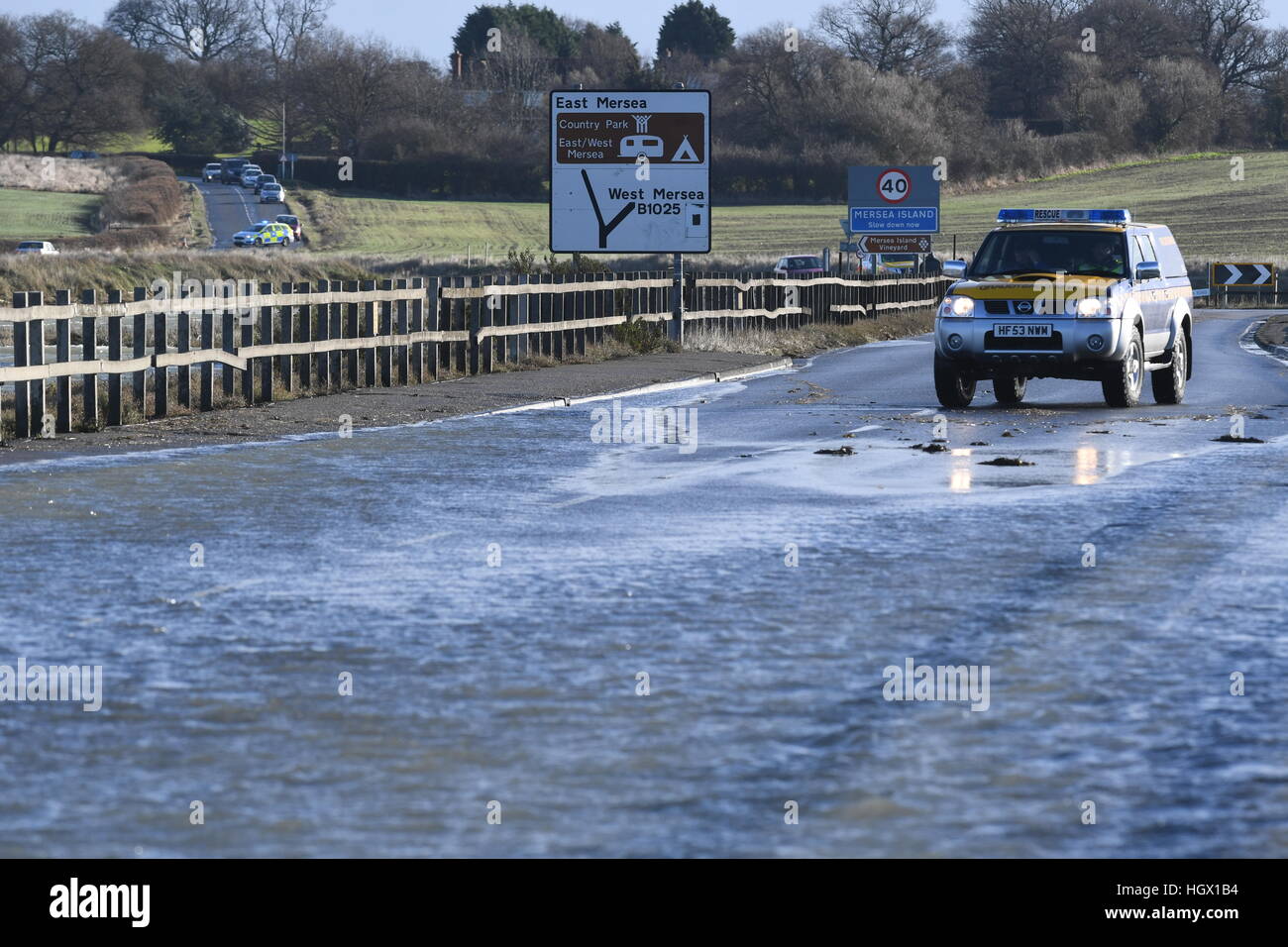 A coastguard at The Strood causeway in Essex as Mersea Island prepares for  flooding at high tide and a possible evacuation of properties Stock Photo -  Alamy