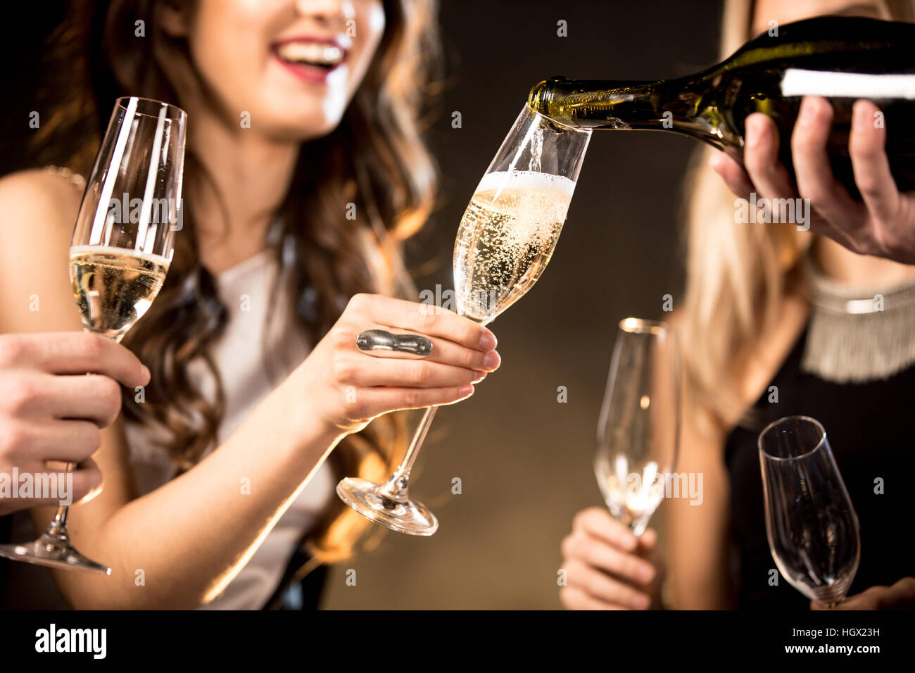 Partial view of happy young friends drinking champagne Stock Photo