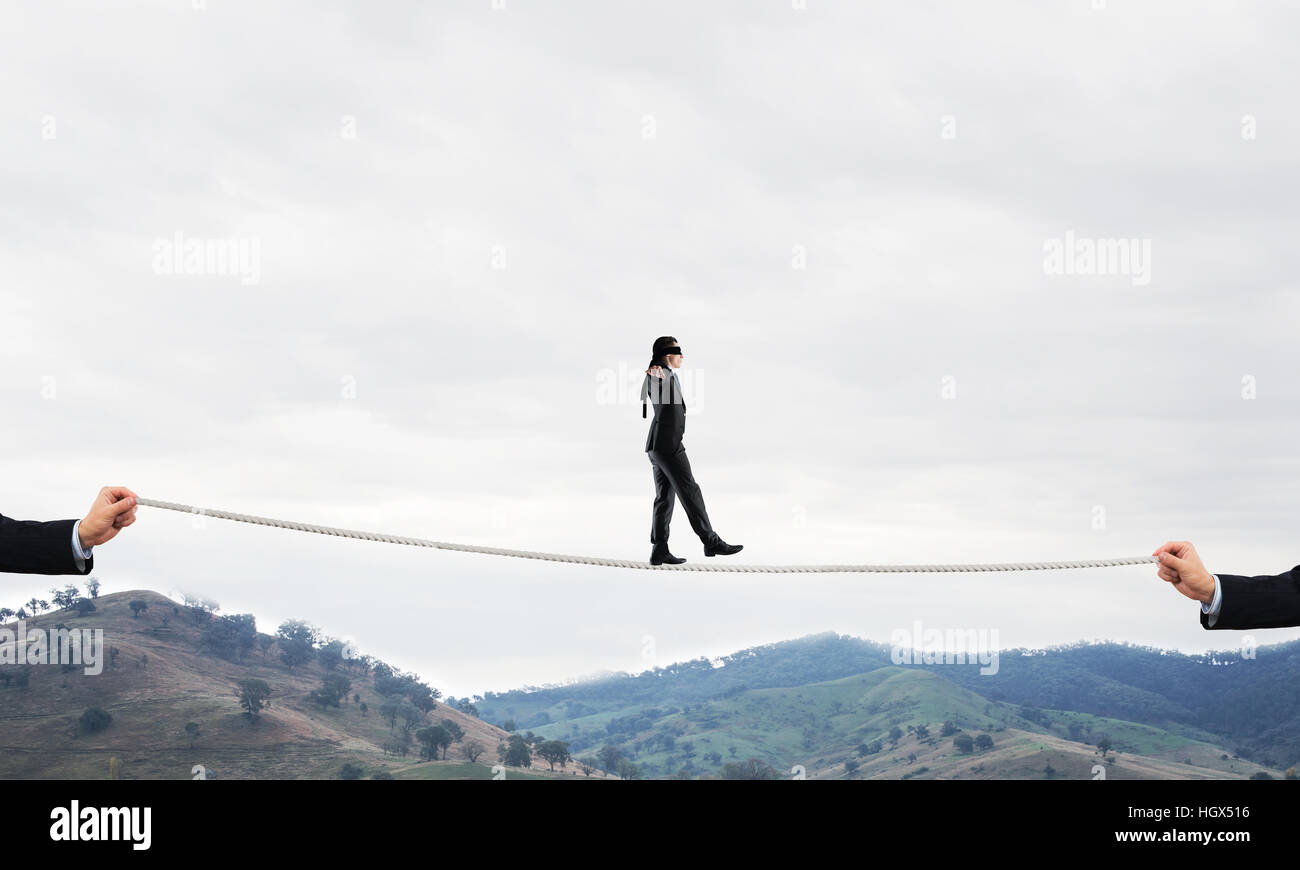 Business concept of risk support and assistance with man balancing on ...