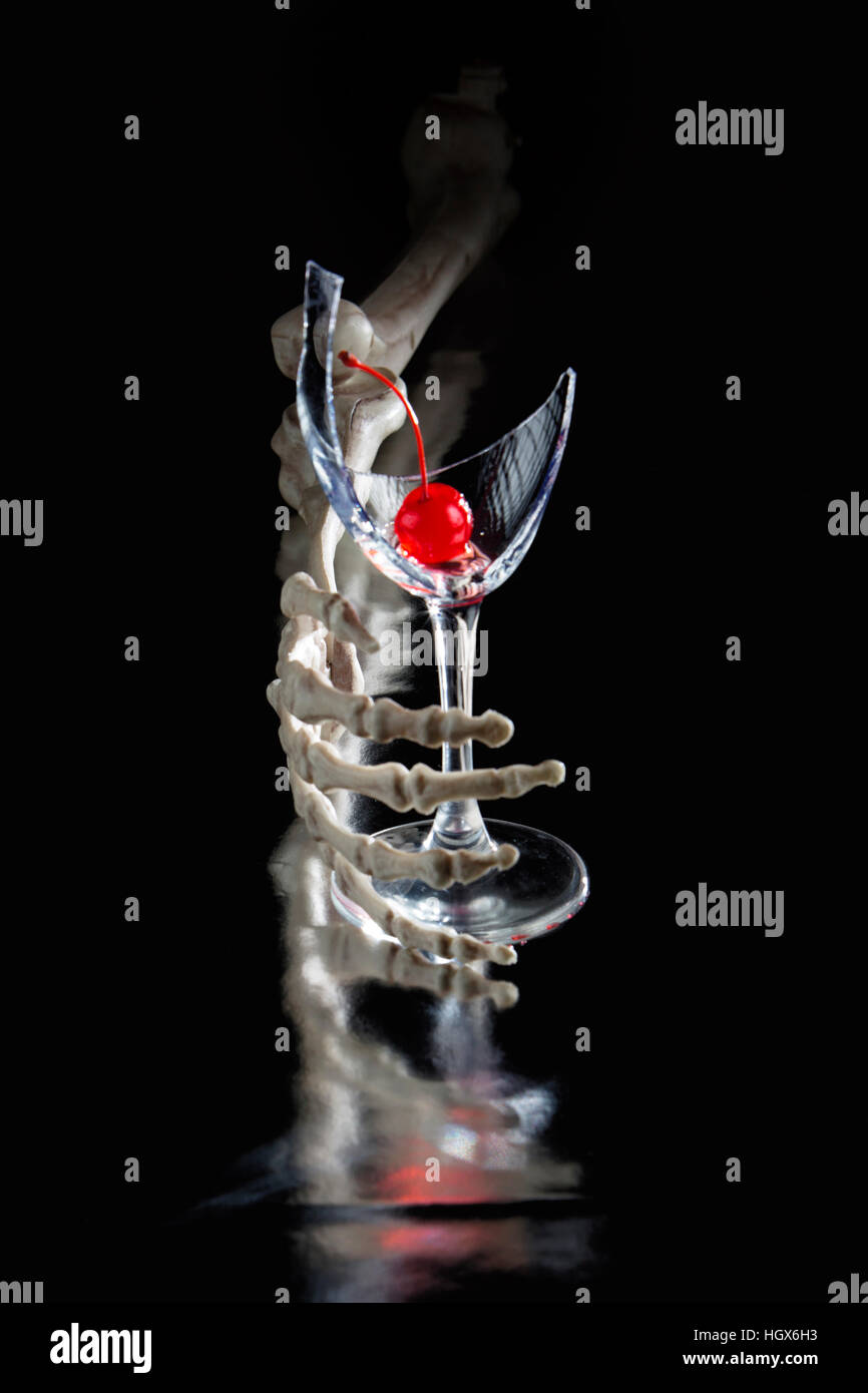 Skeletal Hand Holding A Broken Wine Glass On Black Background With 