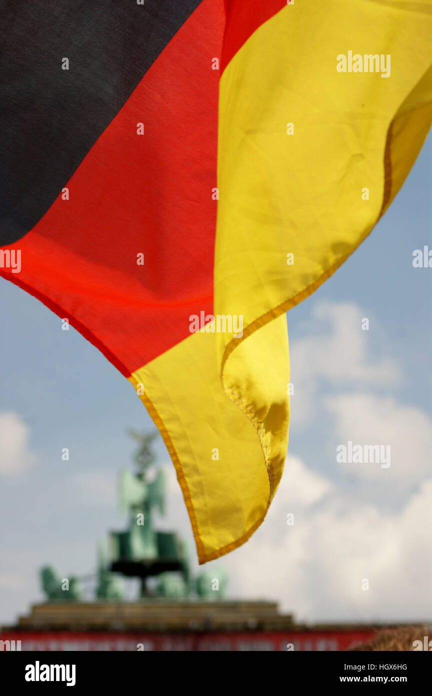 German flag with the Brandenburg Gate quadriga in the background. Stock Photo