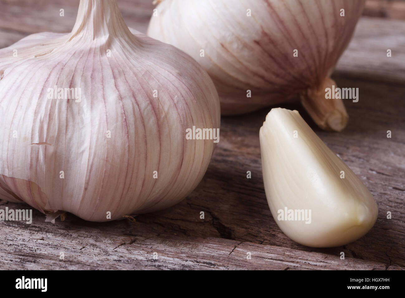 a clove of garlic and a whole wooden table closeup Stock Photo - Alamy