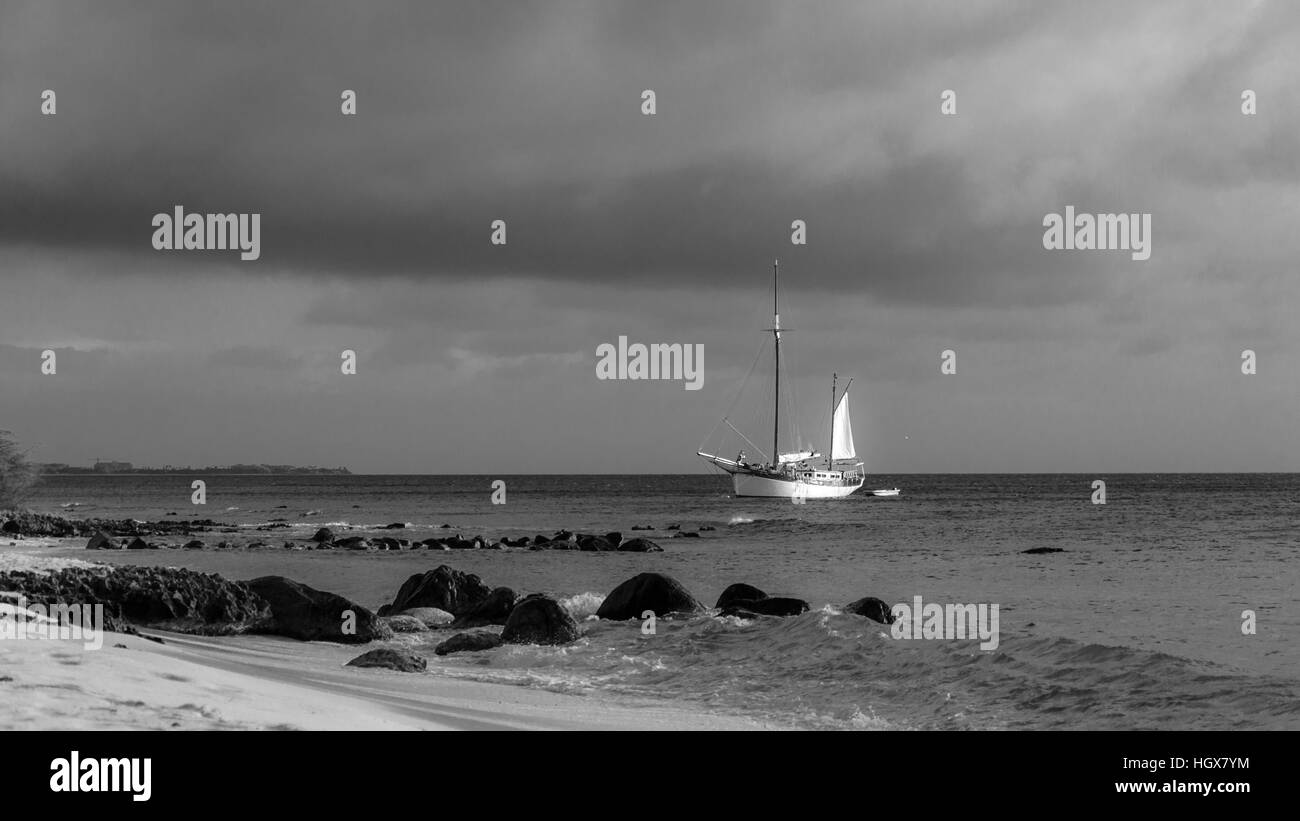 Aruba, Caribbean - September 25, 2012: Picture showing a big sailboat on sea navigating towards the beach. The image was taken from Arashi Beach, Arub Stock Photo