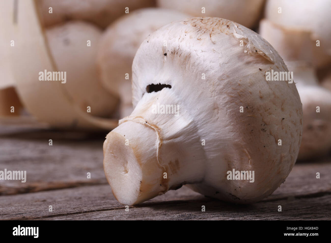 Fresh mushroom champignon macro on the old wooden table. close up. horizontal Stock Photo