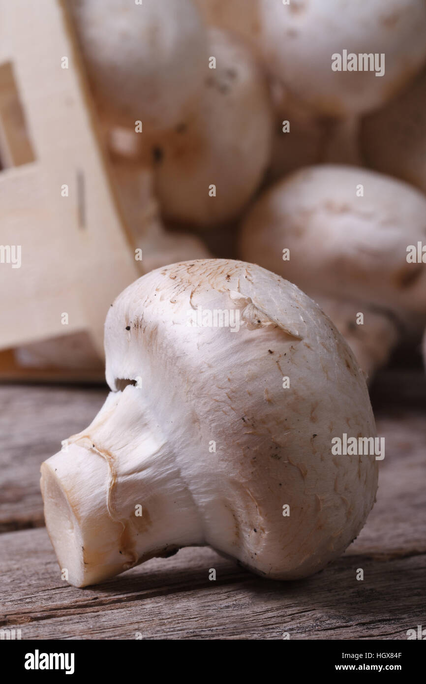 Fresh mushroom champignon macro on the old wooden table. close up.  close up. Vertical Stock Photo