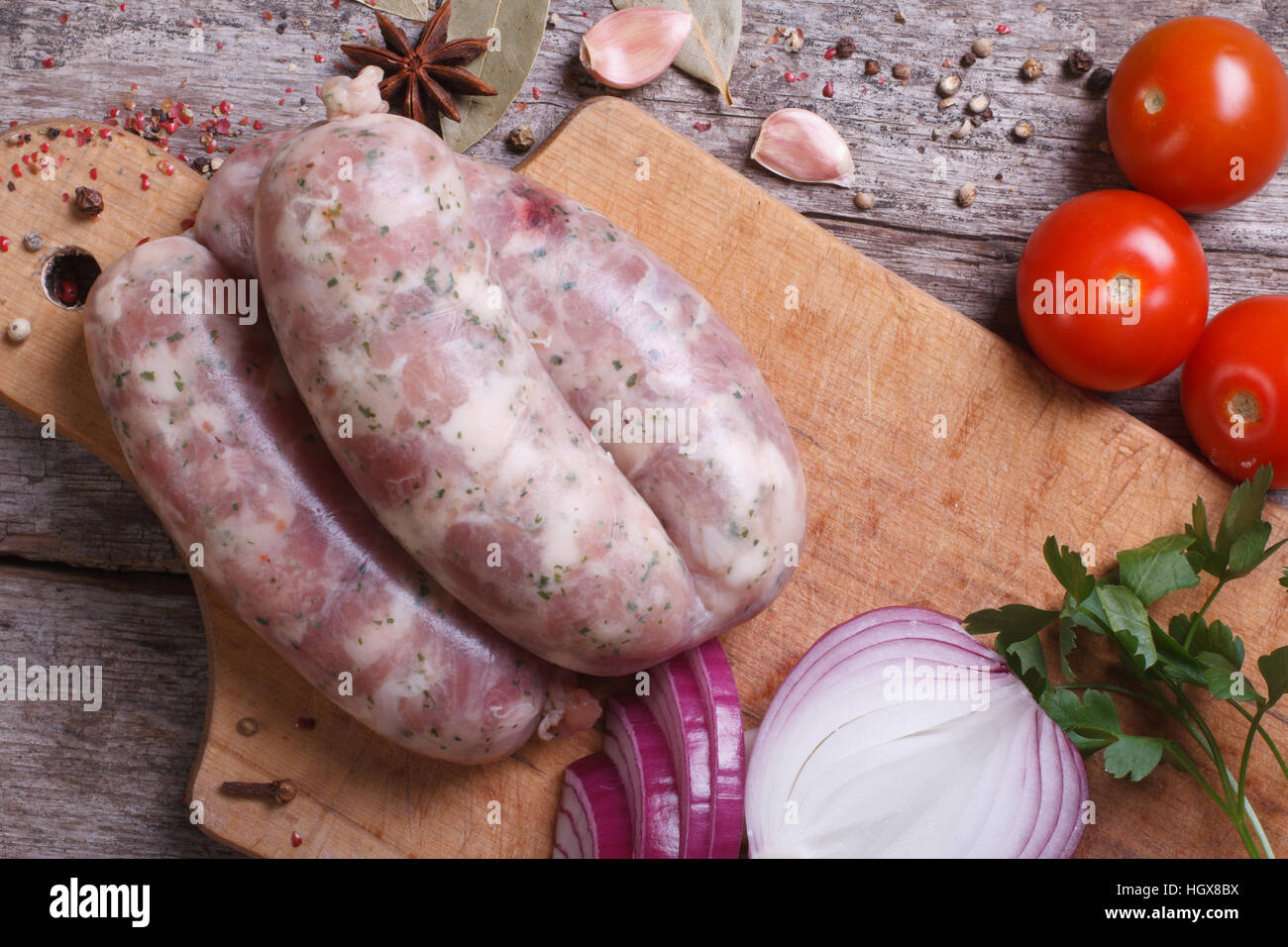 Raw sausage grill on kitchen board with ingredients and spices closeup. top view Stock Photo Alamy