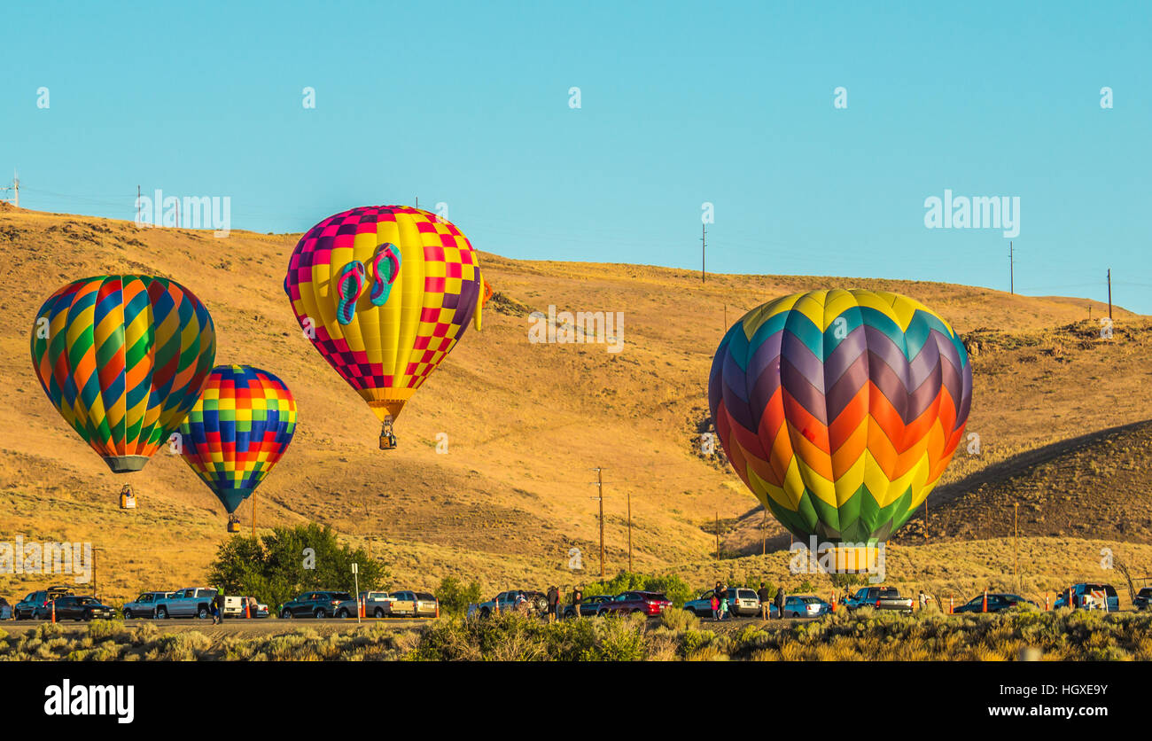 Four Hot Air Balloons Near Parking Lot At Low Level Stock Photo Alamy