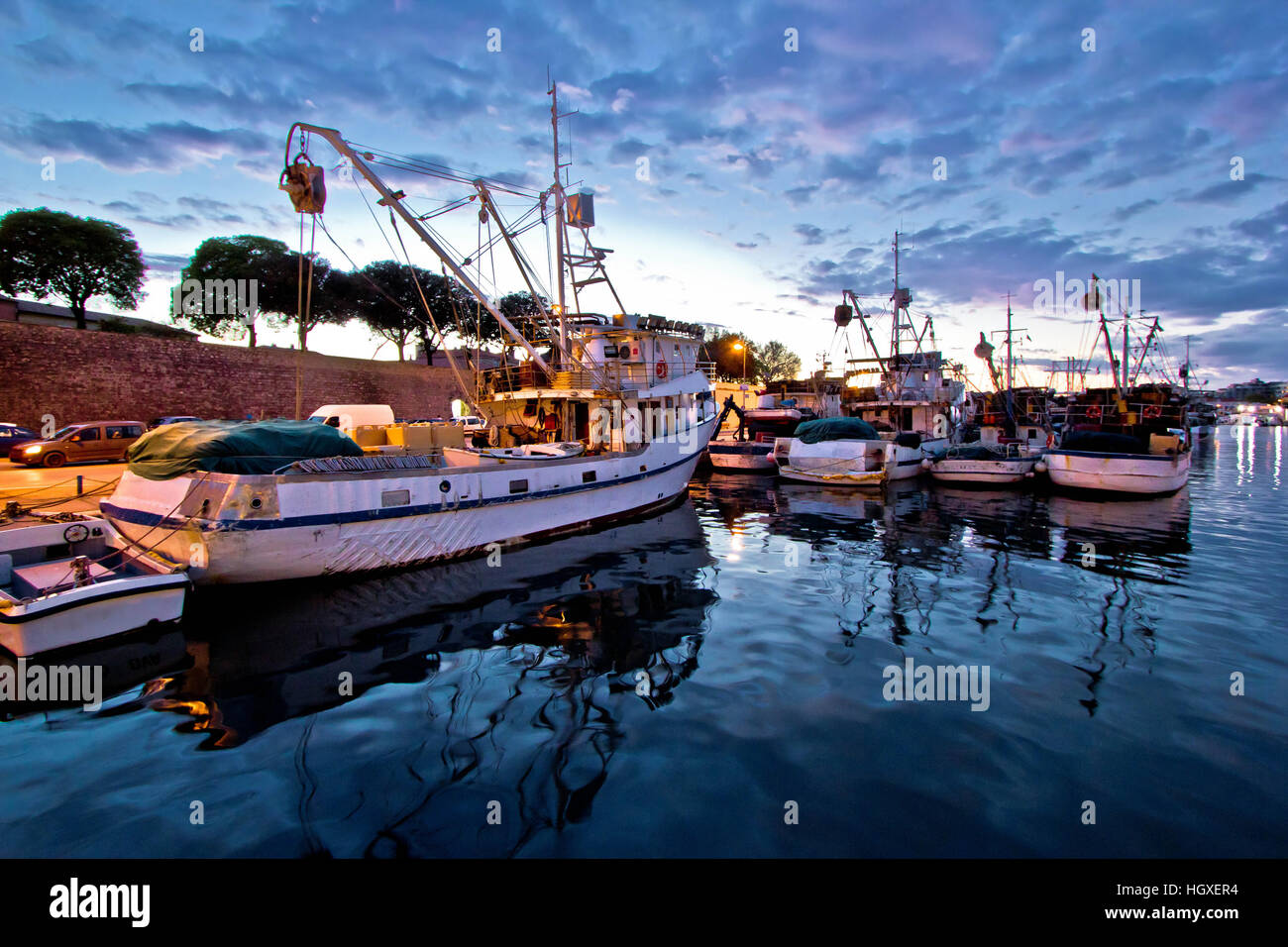 Fishing boats on colorful sunset in Zadar, Croatia Stock Photo Alamy
