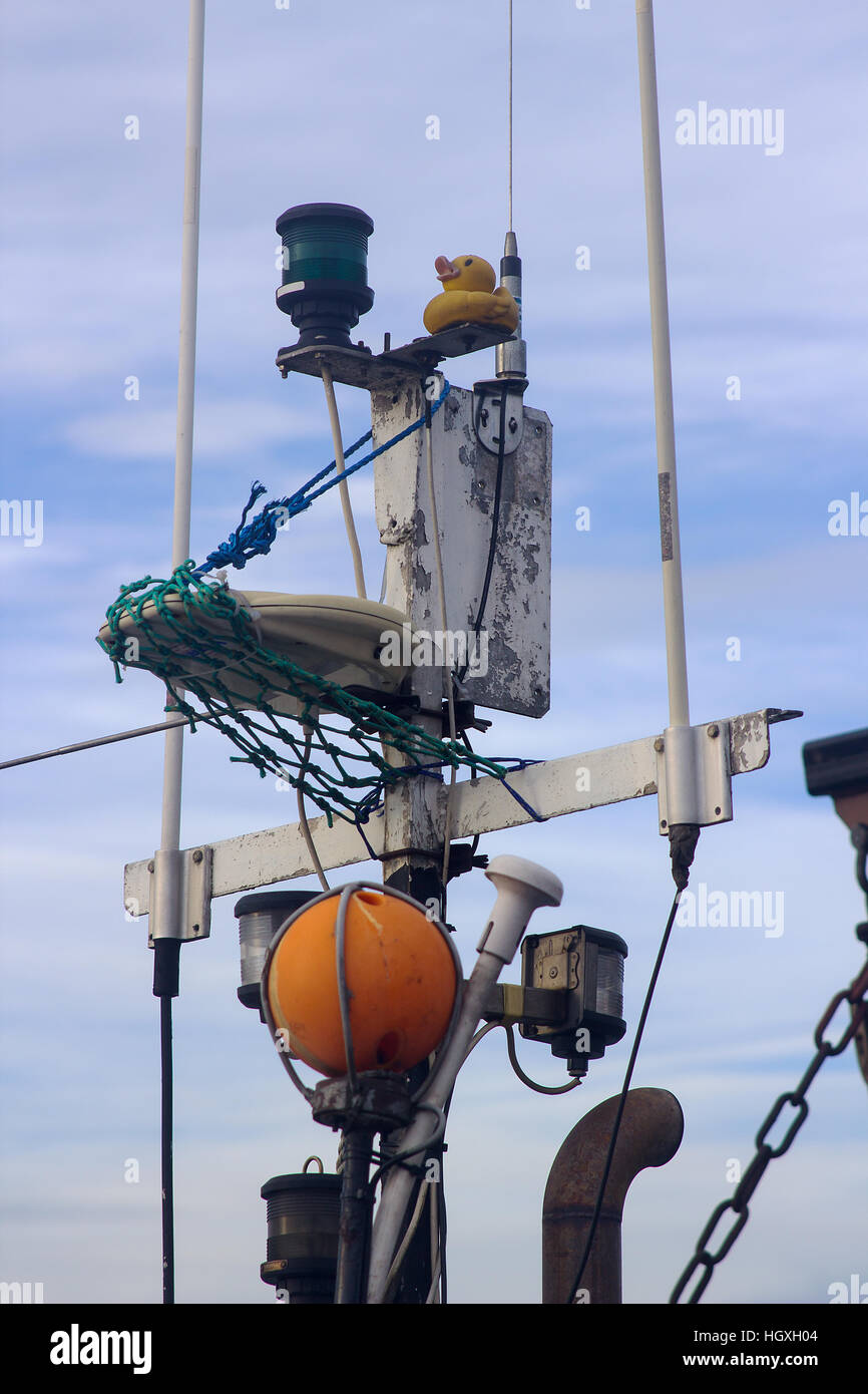 Close up shots of a small trawler mast with navigation lights, ropes, markers and beacons Stock Photo