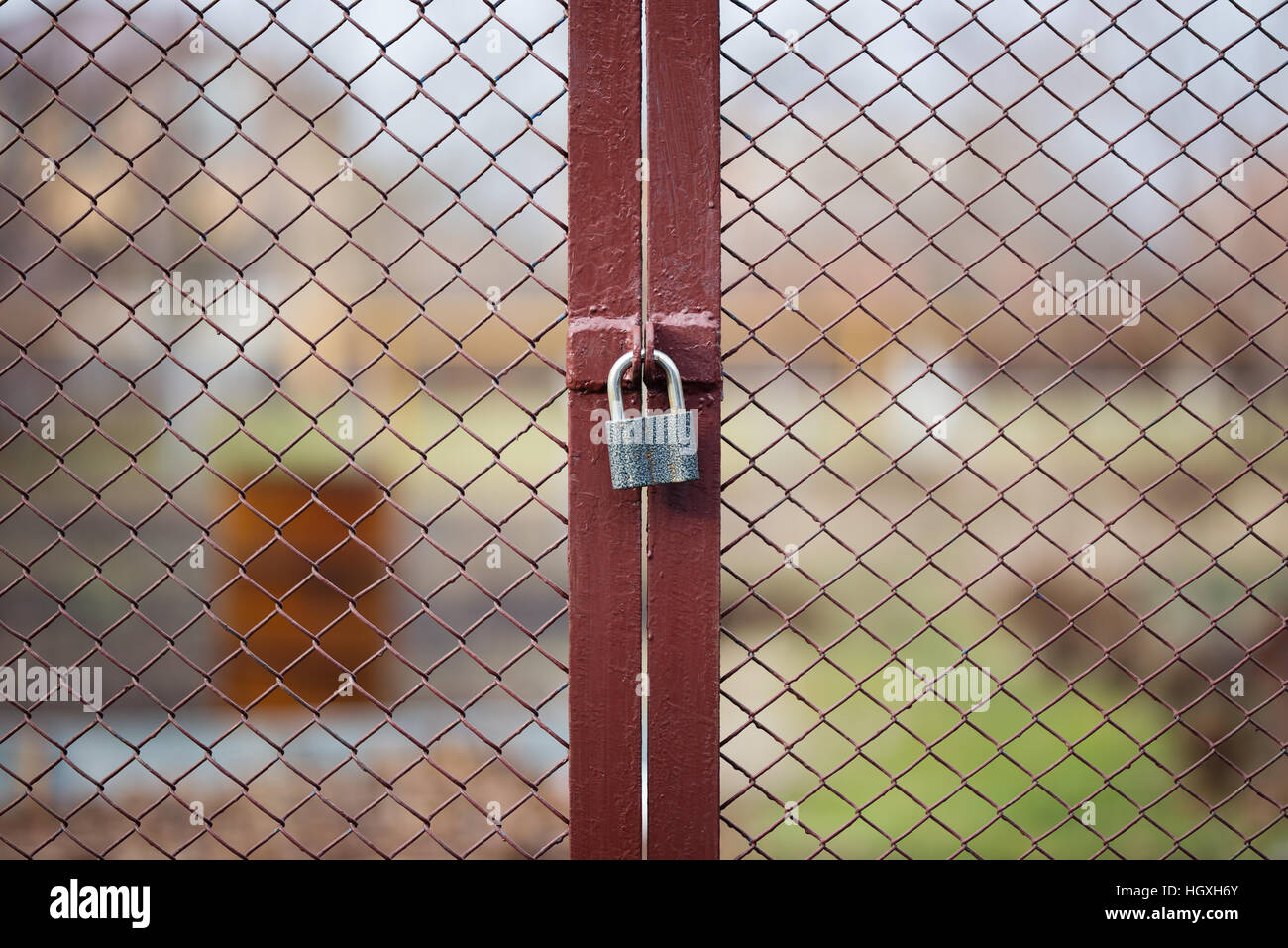 Locked wire mesh fence on private land Stock Photo
