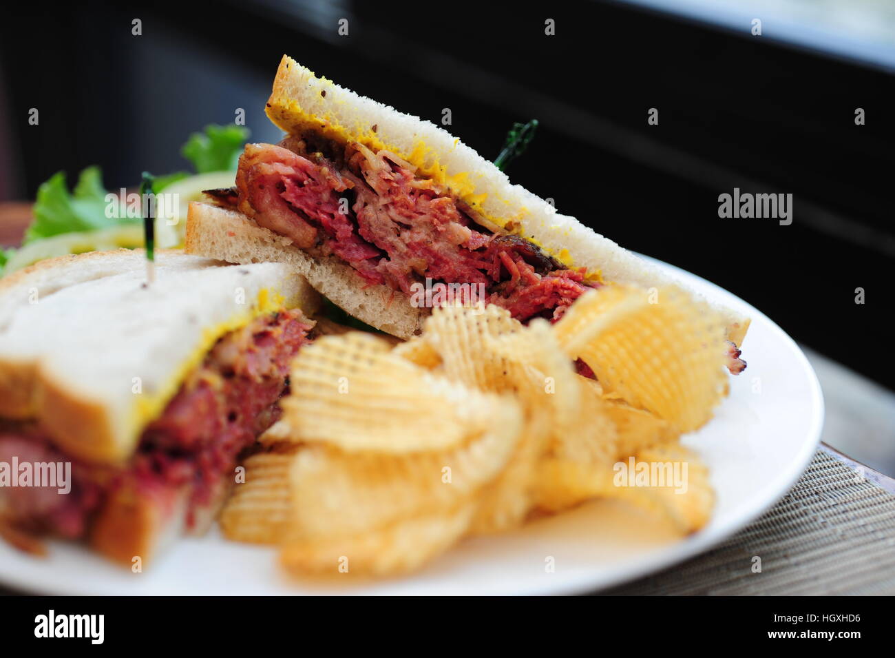 Corned beef on rye bread sandwich with potato chips Jewish deli