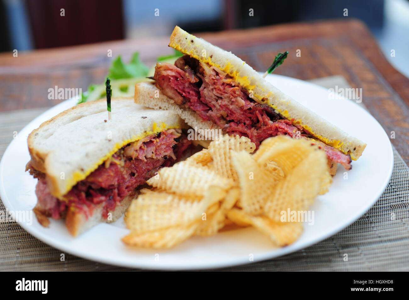 Corned beef on rye bread sandwich with potato chips Jewish deli