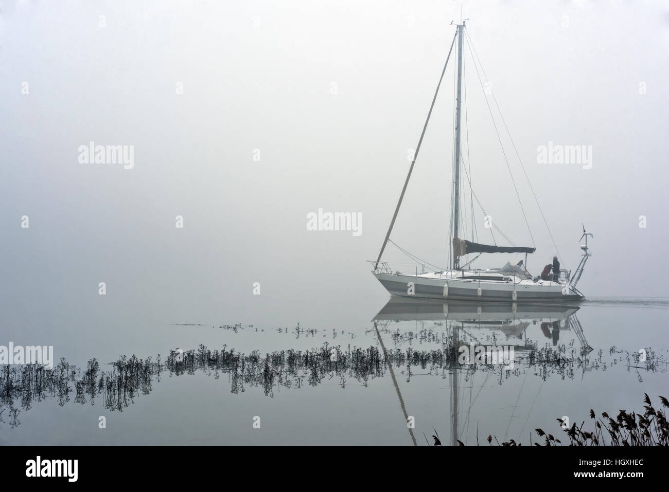 yacht lock thick winter fog below Chatelier Lock Le Lyvet Rance Valley River Rance Brittany France Stock Photo