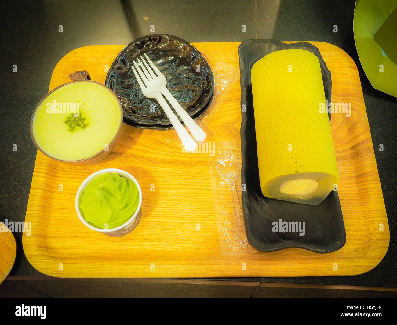Set of green tea roll cake, green tea latte coffee and green tea ice