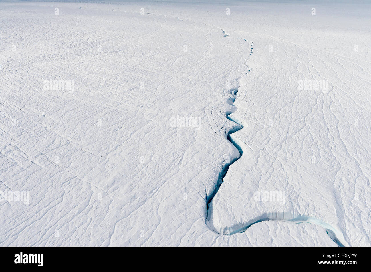 A fracture line dissecting the surface of the ice on the Greenland Ice
