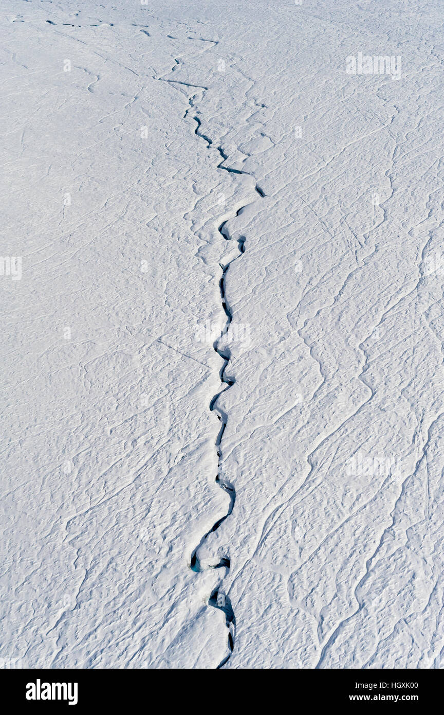 A fracture line dissecting the surface of the ice on the Greenland Ice