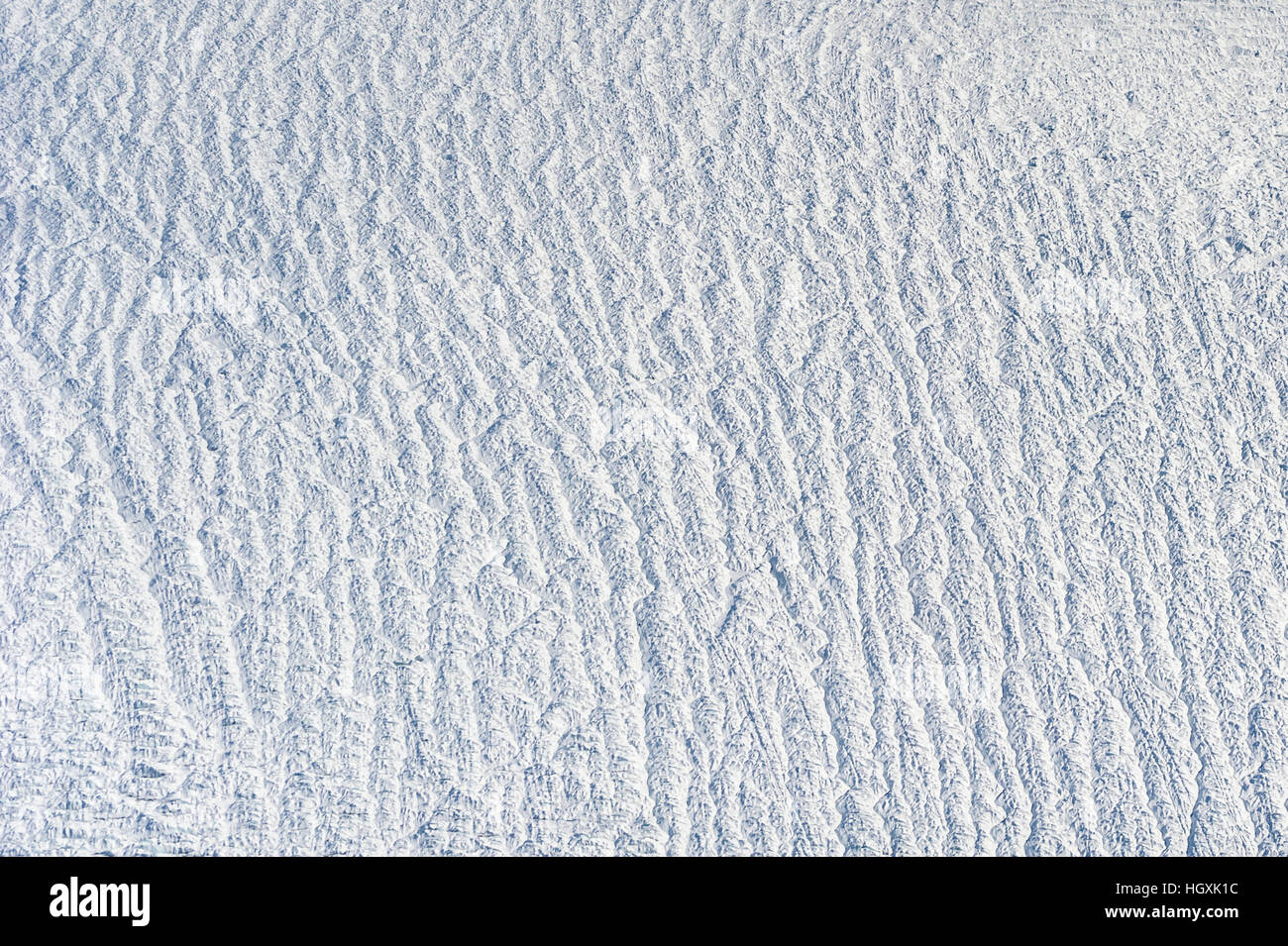 Pressure ridges and crevasse scar the surface of a glacier on the Greenland Ice Sheet. Stock Photo