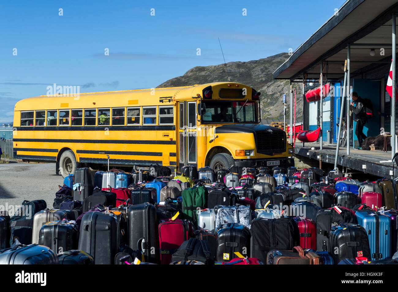 Airport baggage waiting to be loaded onto a bus for passengers. Stock Photo
