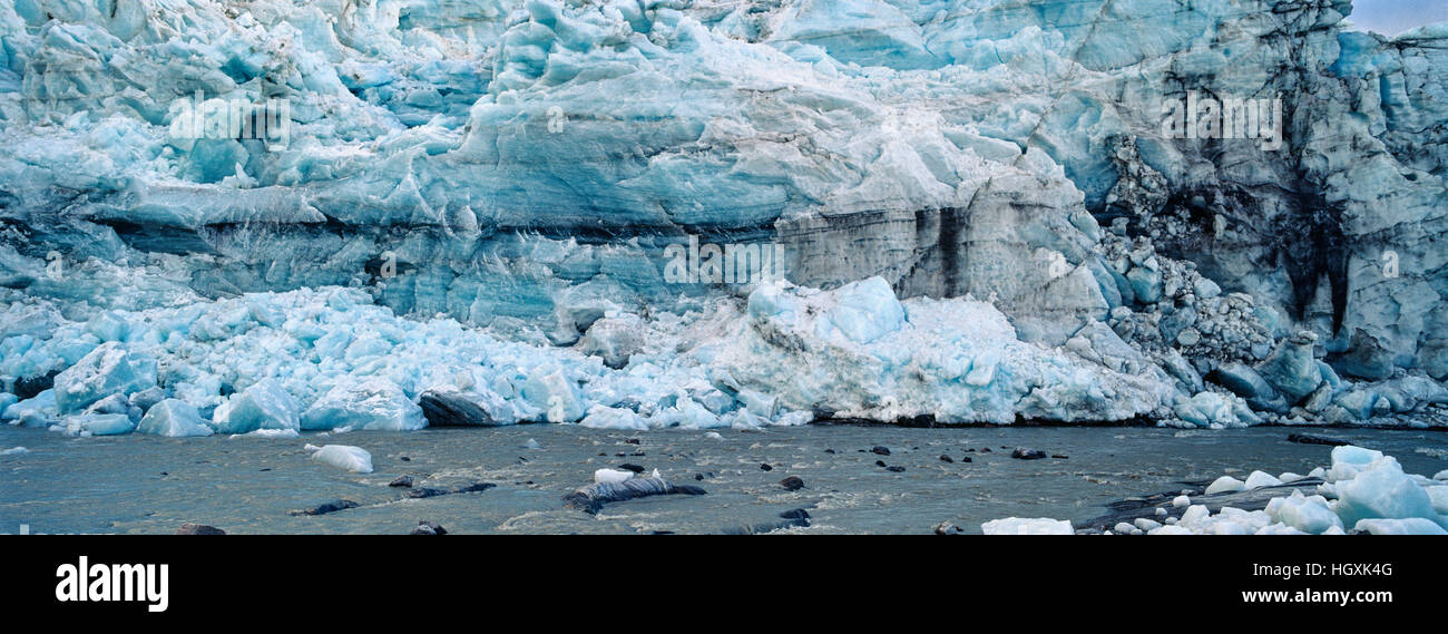 A river flowing along the fracture zone of an enormous glacier. Stock Photo