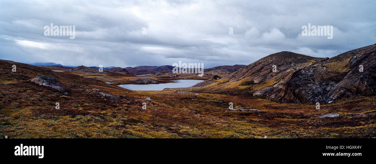 Outcrops of exposed barren rocks emerge through the tundra surrounding ...