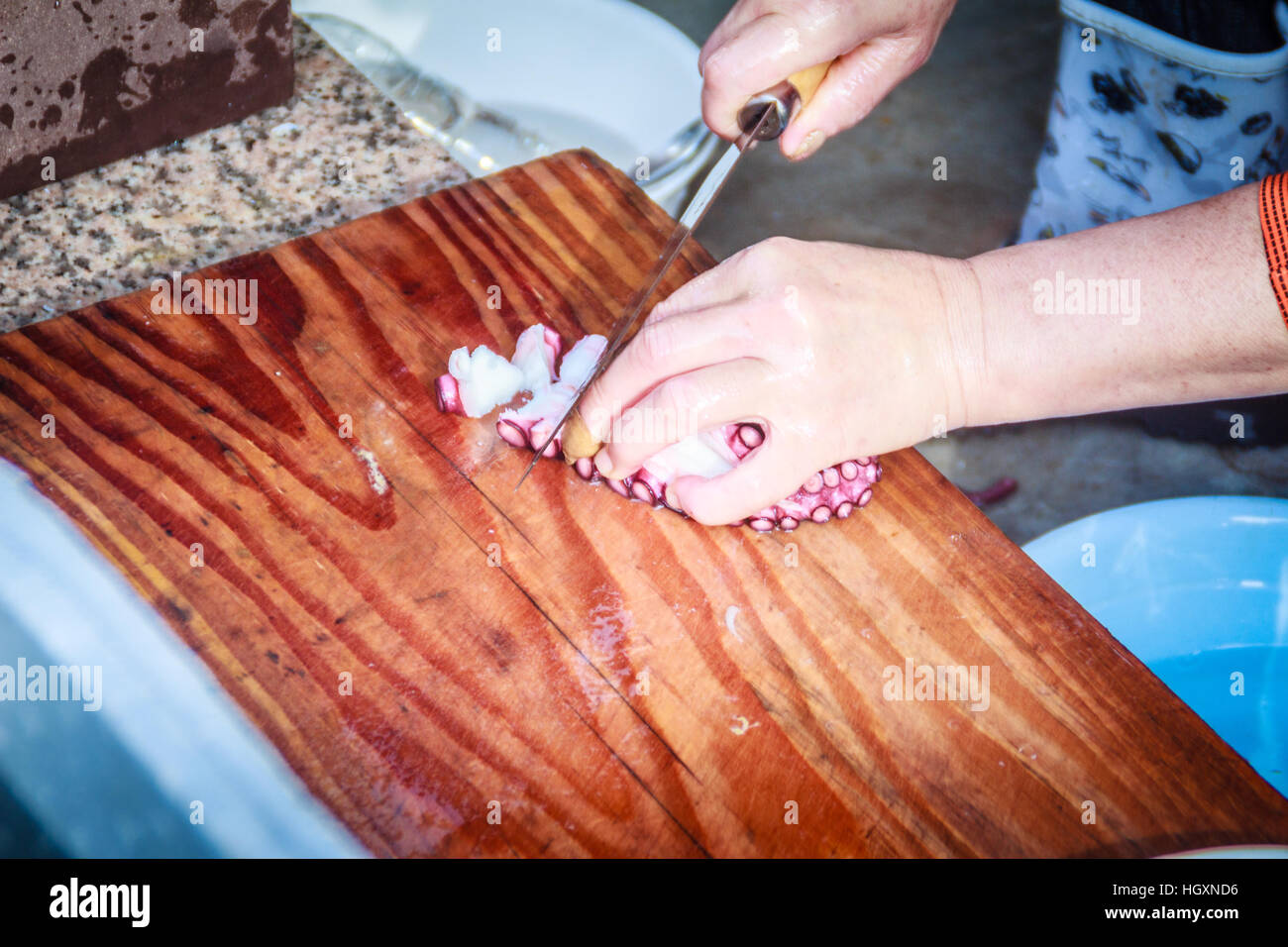 Cooking Raw octopus for sale in seafood shop near Seongaksan mountain, Jeju island, South Korea