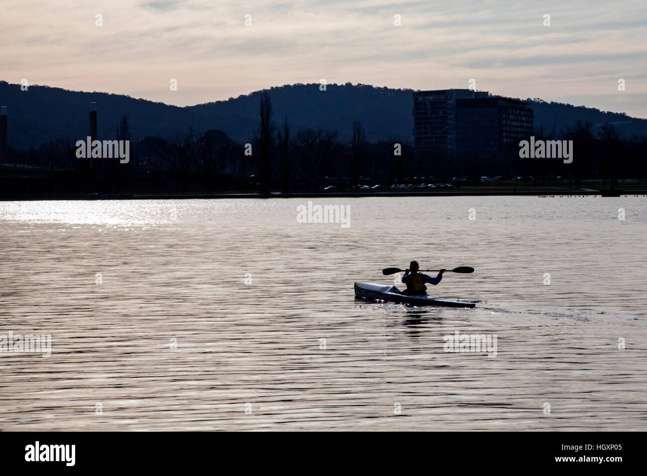Lone paddler on lake silhouette Stock Photo