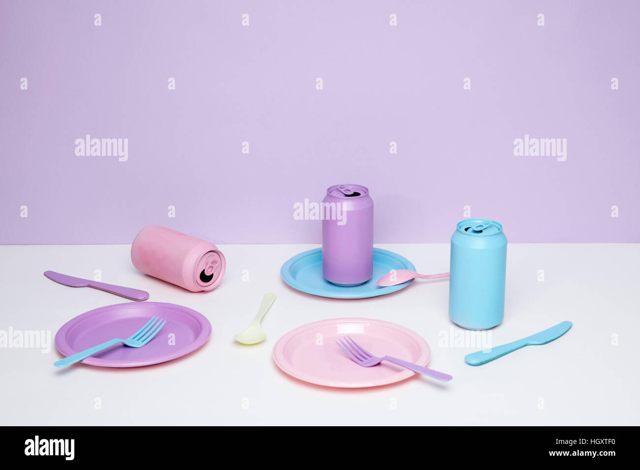 Pastel colored plates, cans, forks and knives Stock Photo