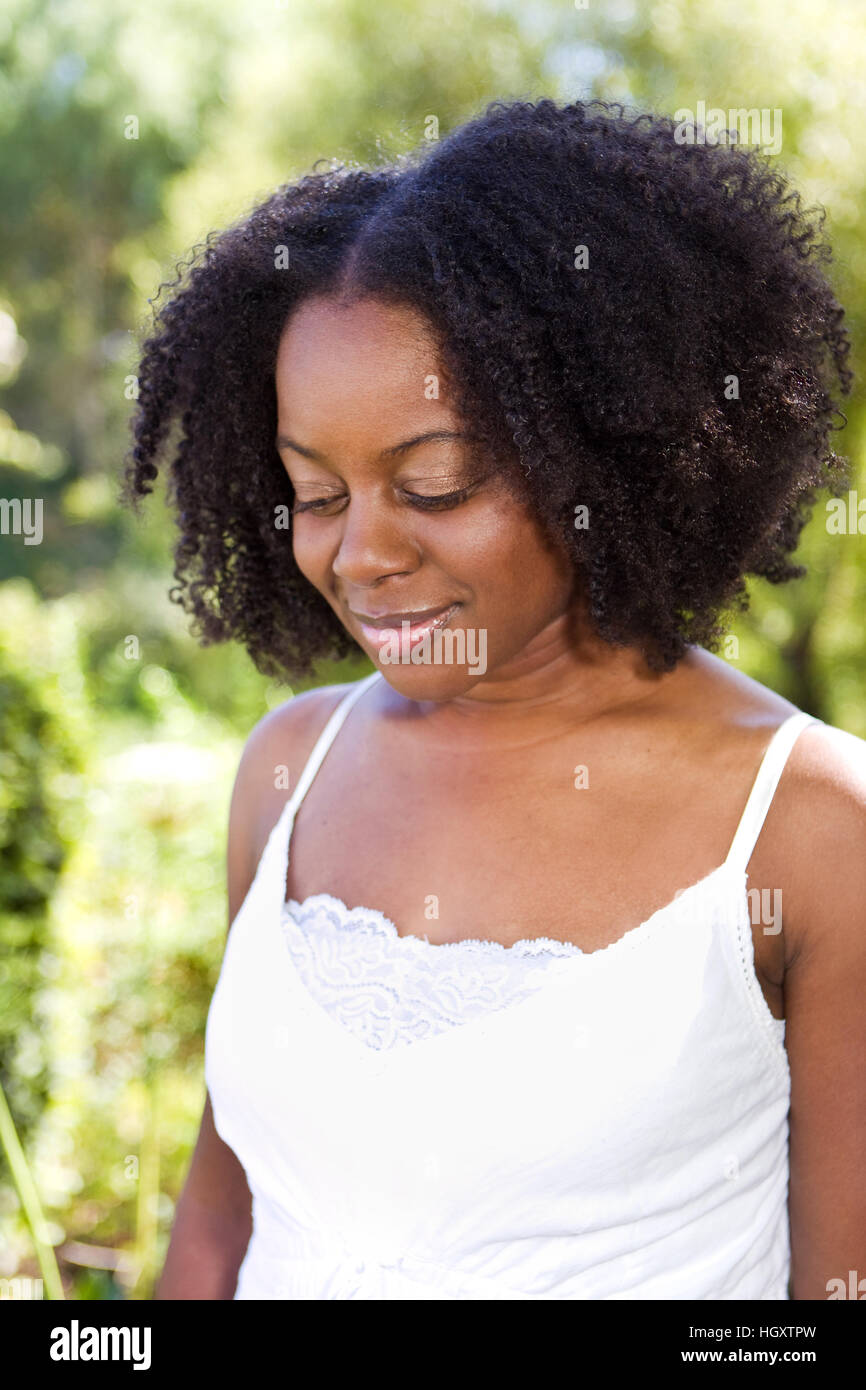 Confident African American woman outside in a garden Stock Photo - Alamy