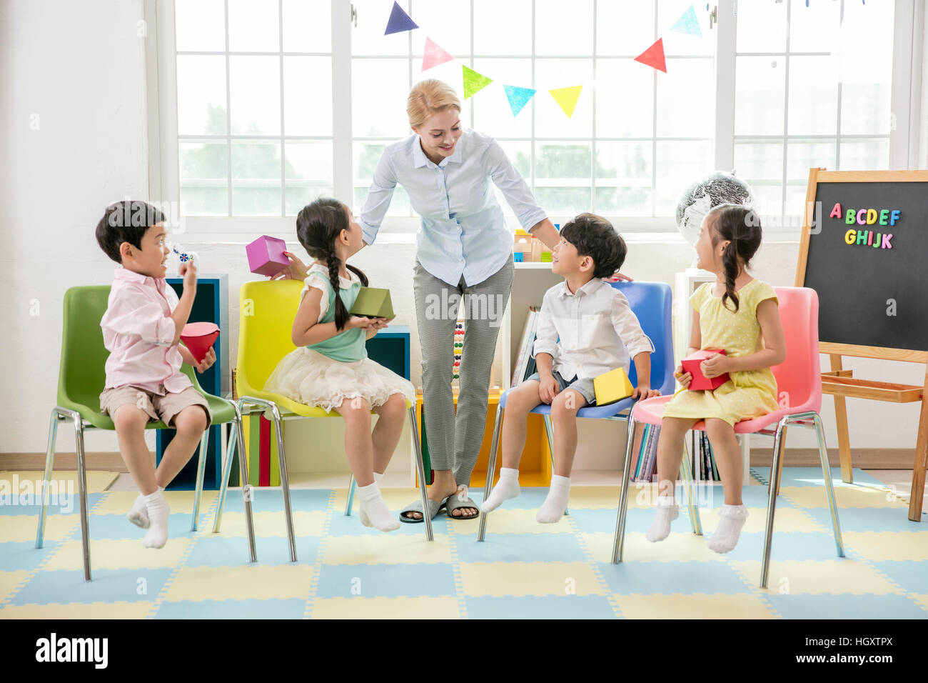Children and their teacher hi-res stock photography and images - Alamy