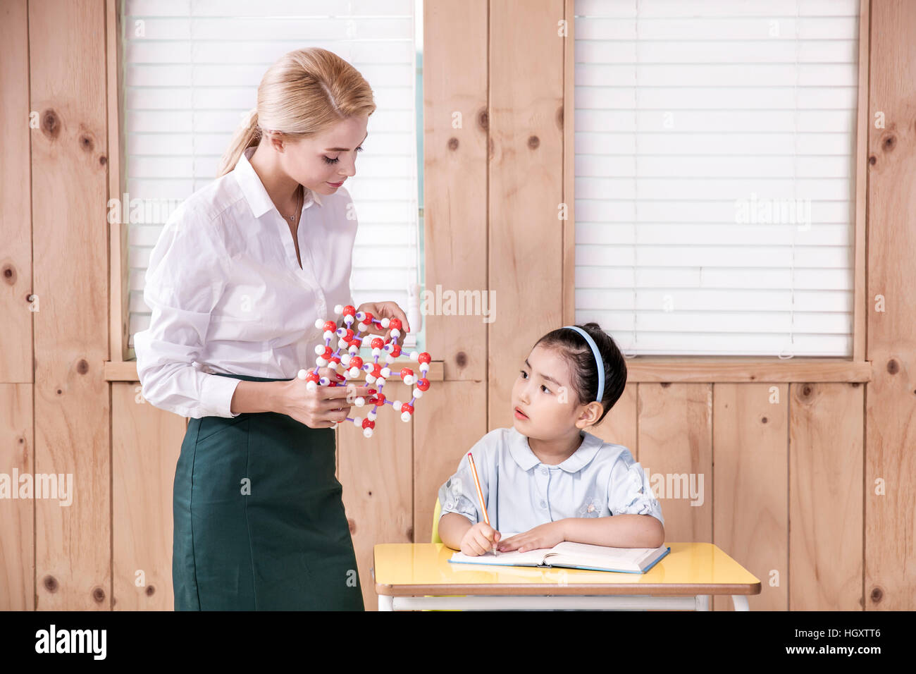 Foreign teacher and kindergarten girl Stock Photo - Alamy