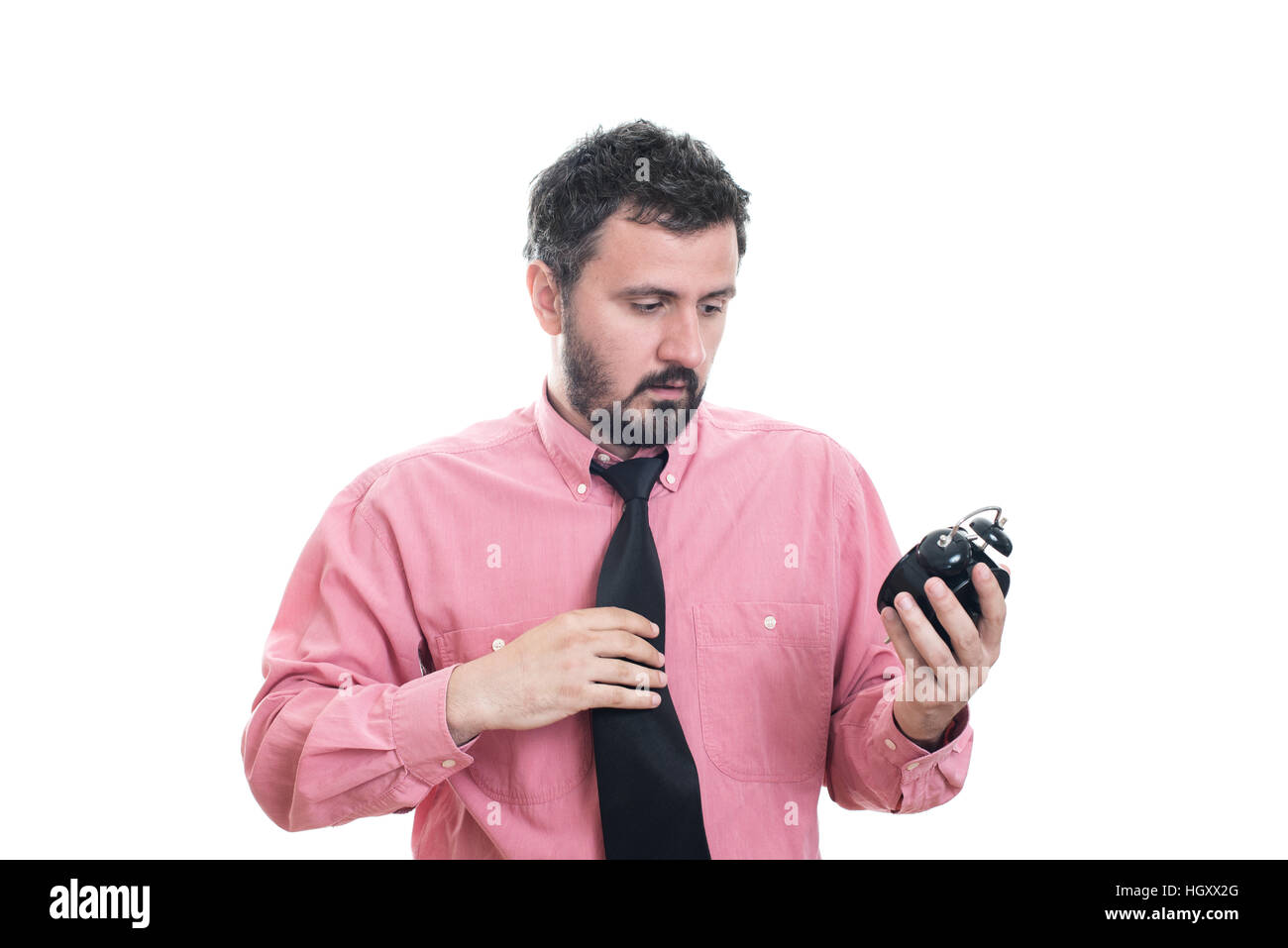 Angry young man holding alarm clock Stock Photo