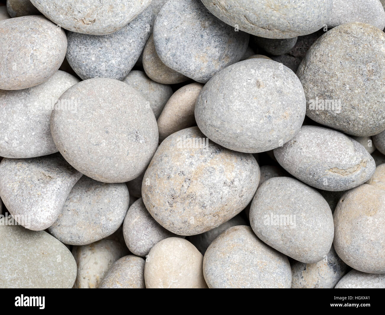 Grey pebbles shot from above Stock Photo