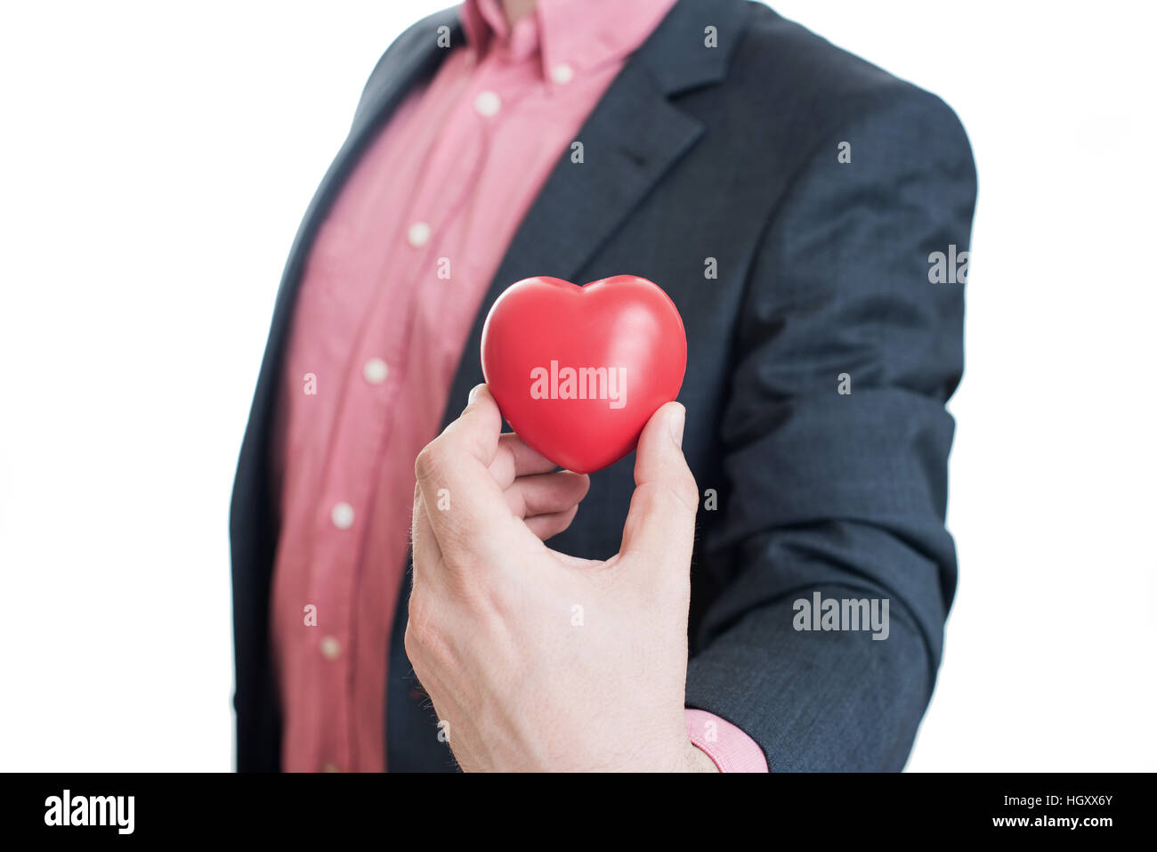 Man holding red heart in his hands Stock Photo - Alamy