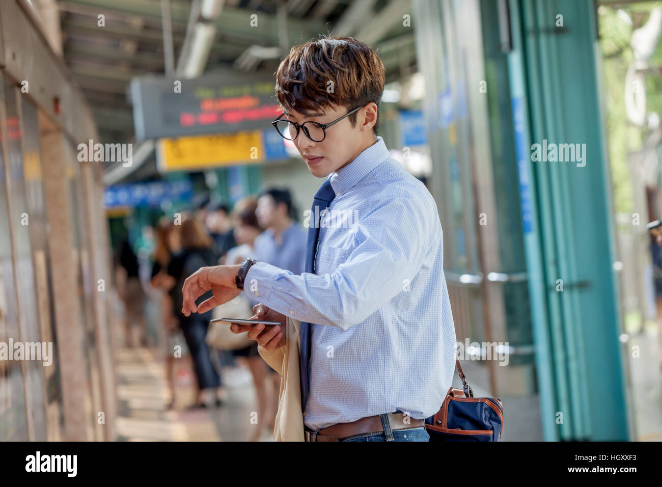 Businessman checking time Stock Photo - Alamy