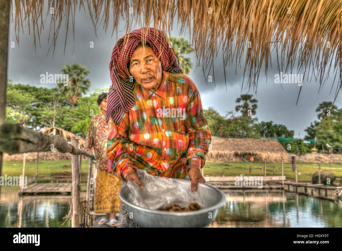 A vendor selling dessert during a picnic on Tonl Bati, a lake and picnic area that has bamboo shacks built over the water. Stock Photo