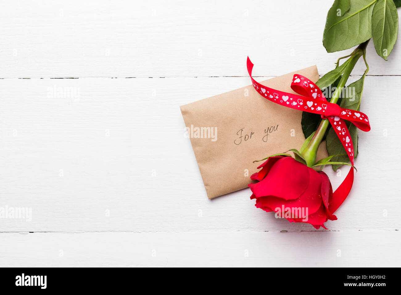 Red rose, love message on a white wooden background Stock Photo - Alamy